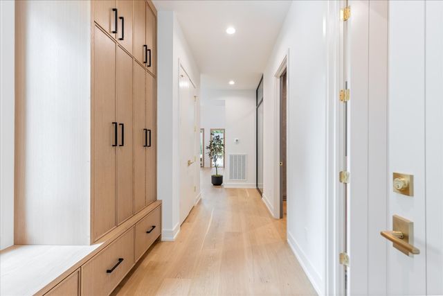 a dining room with furniture a chandelier and wooden floor