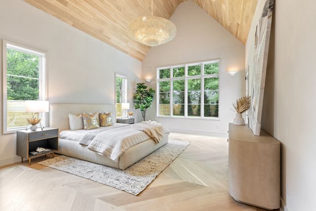 a spacious bathroom with a double vanity sink a mirror and a shower