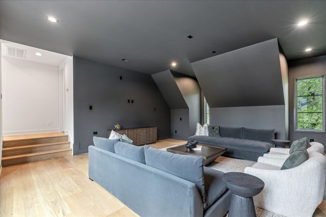 a bathroom with a toilet a sink a tub and mirror