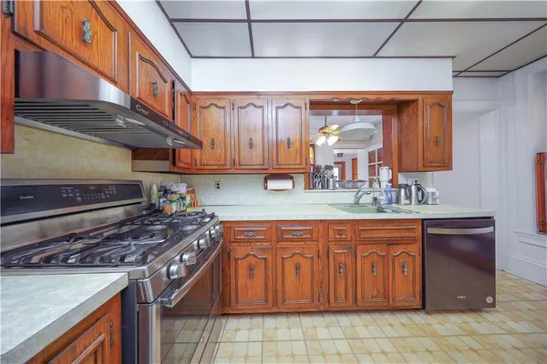 a kitchen with stainless steel appliances granite countertop a stove and a sink