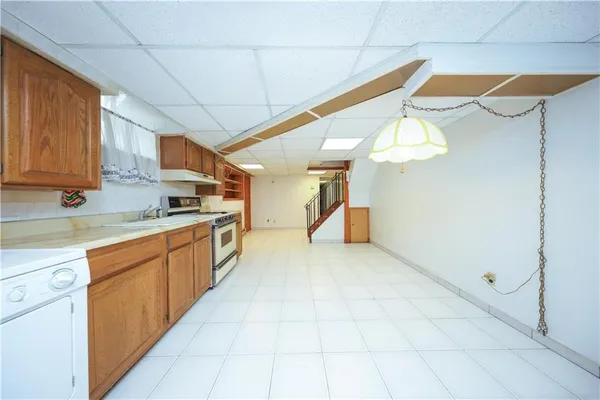 a large kitchen with stainless steel appliances kitchen island granite countertop a sink and cabinets