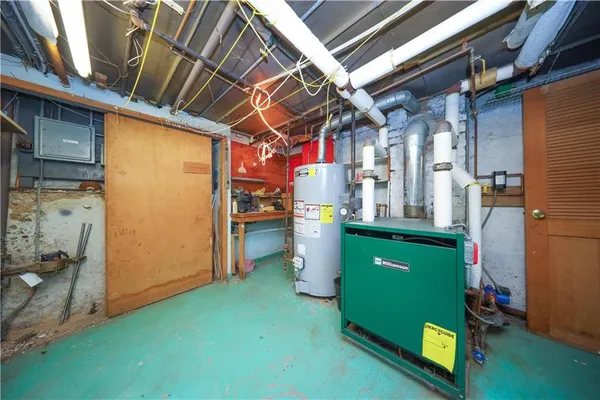 a room with washing machine and storage