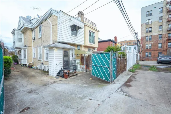 a view of a house with wooden fence