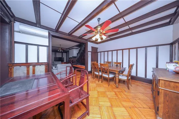 a view of a room with furniture and wooden floor