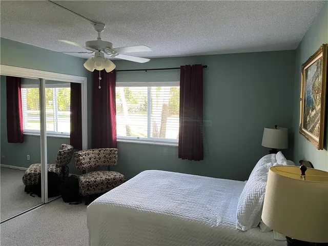 a bedroom with bed and window