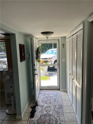 a view of hallway with furniture and a window
