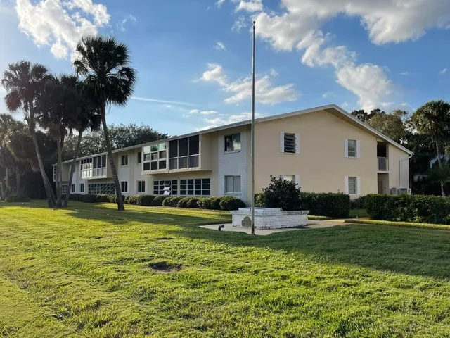a front view of a house with a yard table and chairs