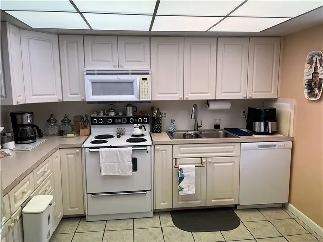 a kitchen with cabinets appliances and a sink
