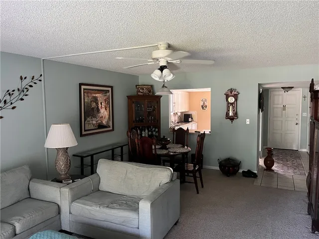 a living room with furniture a chandelier and a window