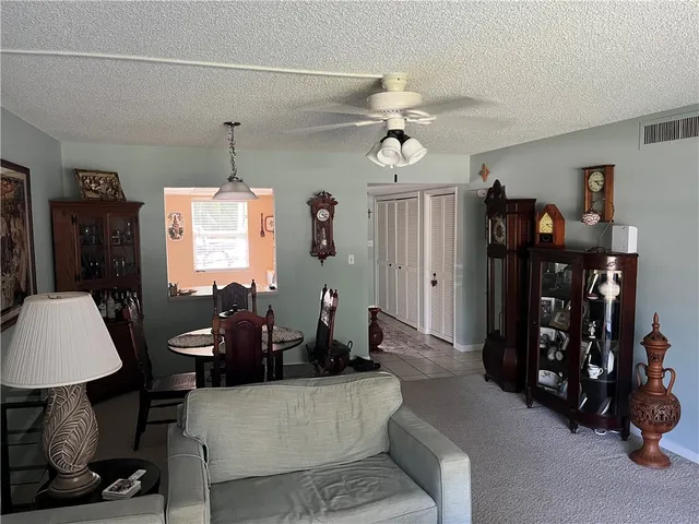 a living room with furniture a chandelier and a window