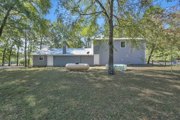 a house that has a tree in front of it