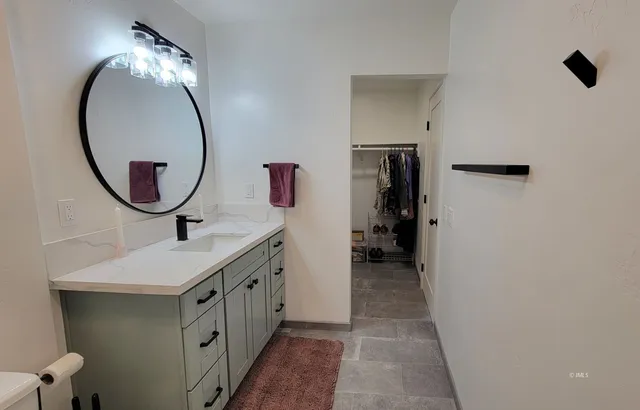 a bathroom with a sink and a mirror