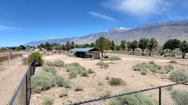 a view of a dry yard with a barn