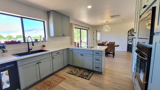 a kitchen with a sink stove and cabinets