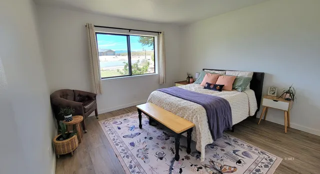 a bed room with a bed and a chair