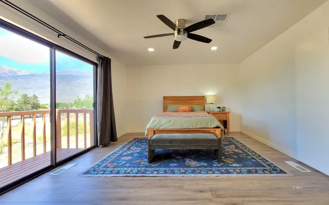 a room with a bed and wooden floor