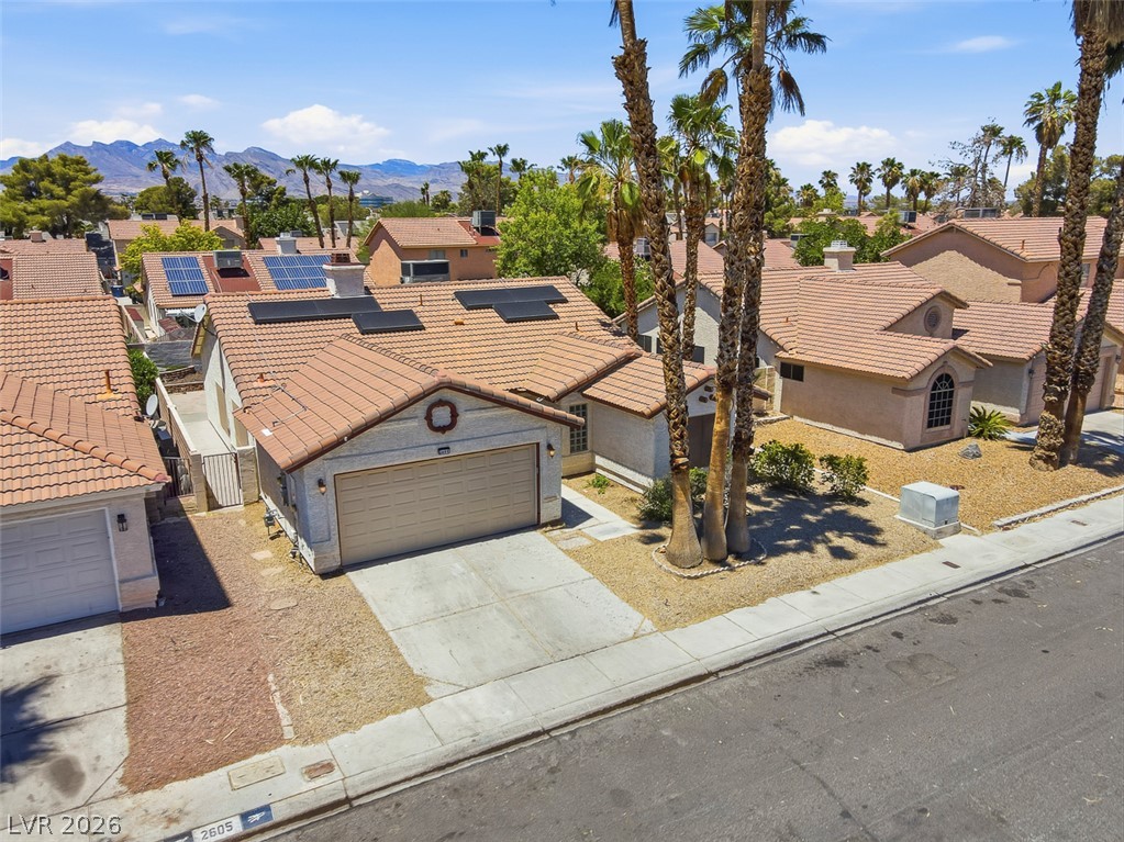 2609 Shakespeare Road Las Vegas, NV 89108 - Photo 38 of 41 A terracotta-tiled roof crowns this residence, featuring integrated solar panels and an attached garage.