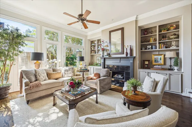 a living room with furniture a ceiling fan and a window