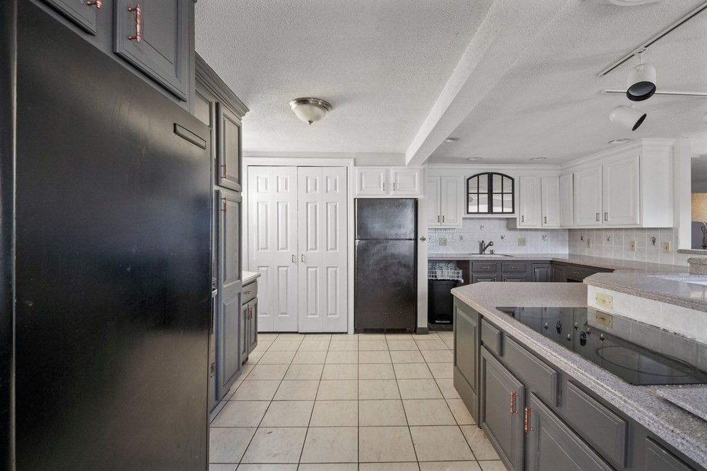 56 Rosedale Avenue Springfield, MA 01128 - Photo 9 of 31 a kitchen with a refrigerator a sink and cabinets