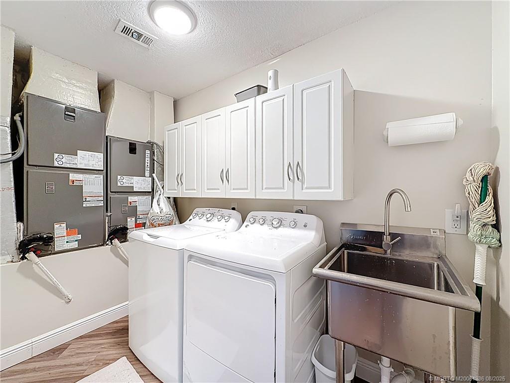 2082 Southeast Pyramid Road Port St. Lucie, FL 34952 - Photo 52 of 87 WASHER AND DRYER, UTILITY ROOM, DUAL AC UNITS, CABINETS