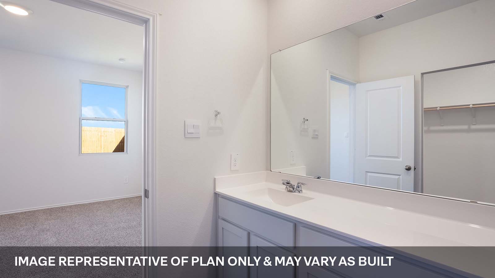 1165 Celosia Loop Kyle, TX 78640 - Photo 11 of 18 a bathroom with a sink a mirror and a vanity