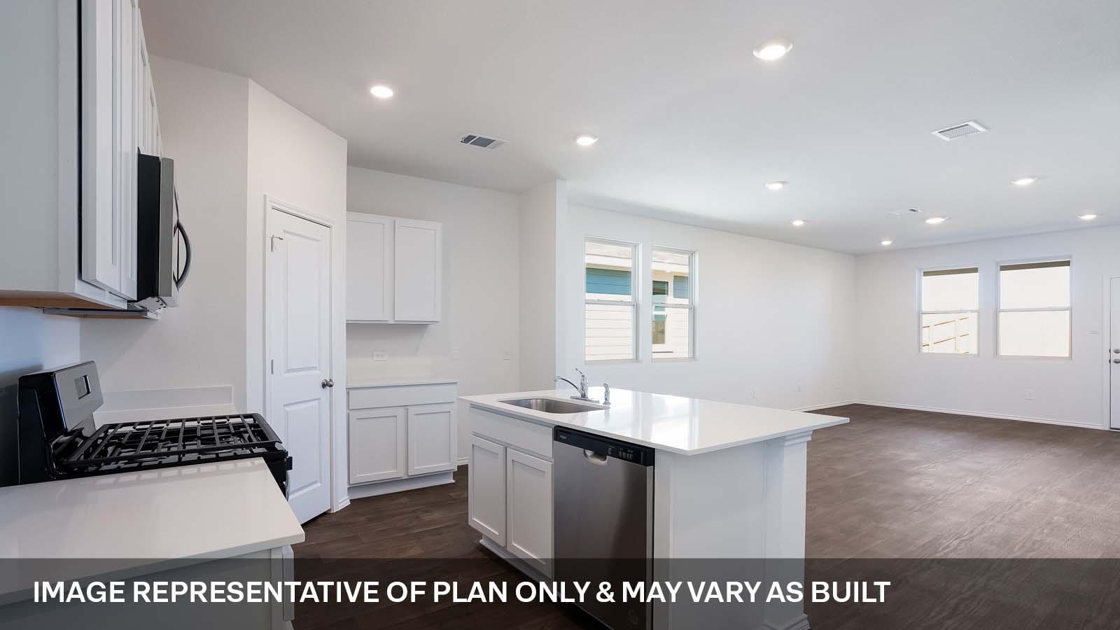 1165 Celosia Loop Kyle, TX 78640 - Photo 3 of 18 a kitchen with a sink a stove a refrigerator and white cabinets