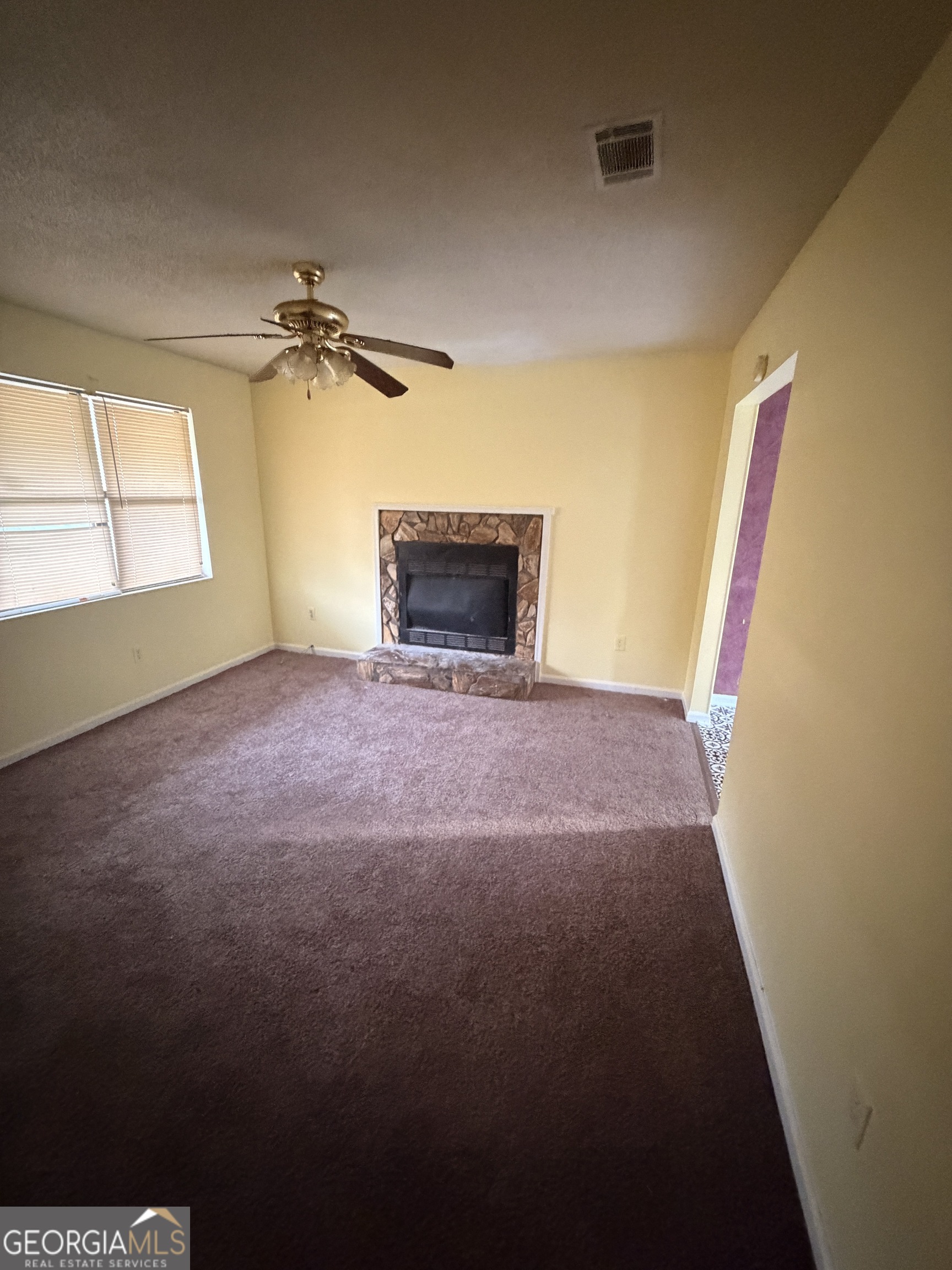 3523 Morgan Road Hephzibah, GA 30815 - Photo 12 of 15 an empty room with windows and chandelier fan