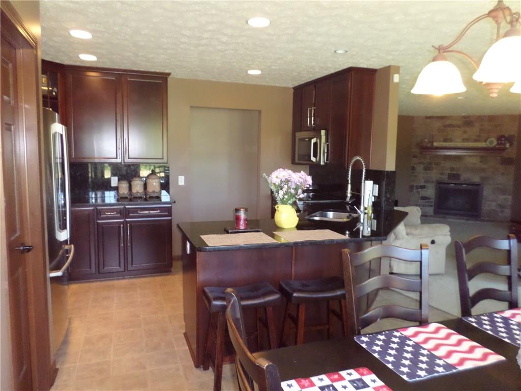 384 Harts Road Carmichaels, PA 15320 - Photo 2 of 25 OPEN AND SPACIOUS GOURMET KITCHEN with top of the line cherry cabinetry, granite counter tops, top of the line stainless steel appliances, kitchen island breakfast bar as well as eat in kitchen table