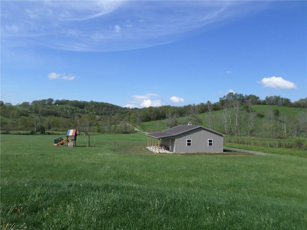 384 Harts Road Carmichaels, PA 15320 - Photo 21 of 25 30 x 30 steel building with 2 oversized garage doors on the side and a 10' overhang on the front