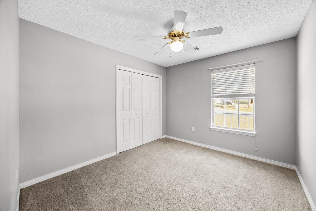 439 Northview Lane Crestview, FL 32536 - Photo 19 of 32 an empty room with windows and fan