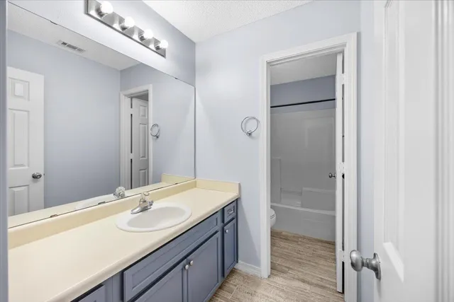 a bathroom with a double vanity sink mirror and shower