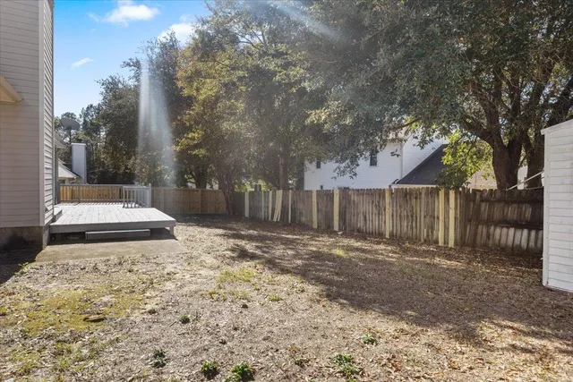 a view of a backyard with wooden fence