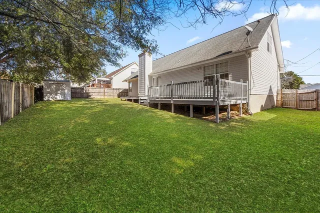 a view of a house with a backyard
