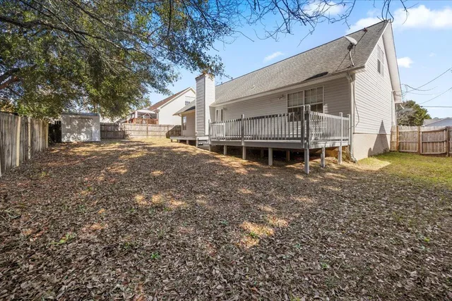 a white house that has a tree in front of it