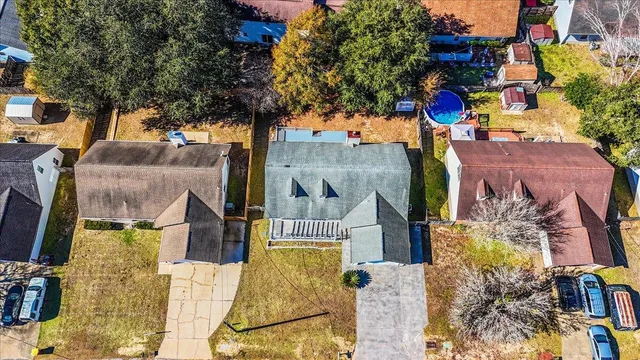 an aerial view of residential houses with outdoor space