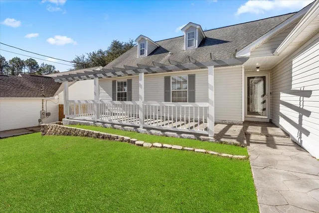 a front view of a house with a yard table and chairs
