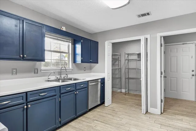 a kitchen with a sink cabinets and window