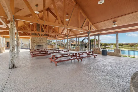 a view of a gym with pool table and chairs