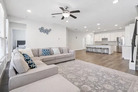 a living room with furniture and kitchen view