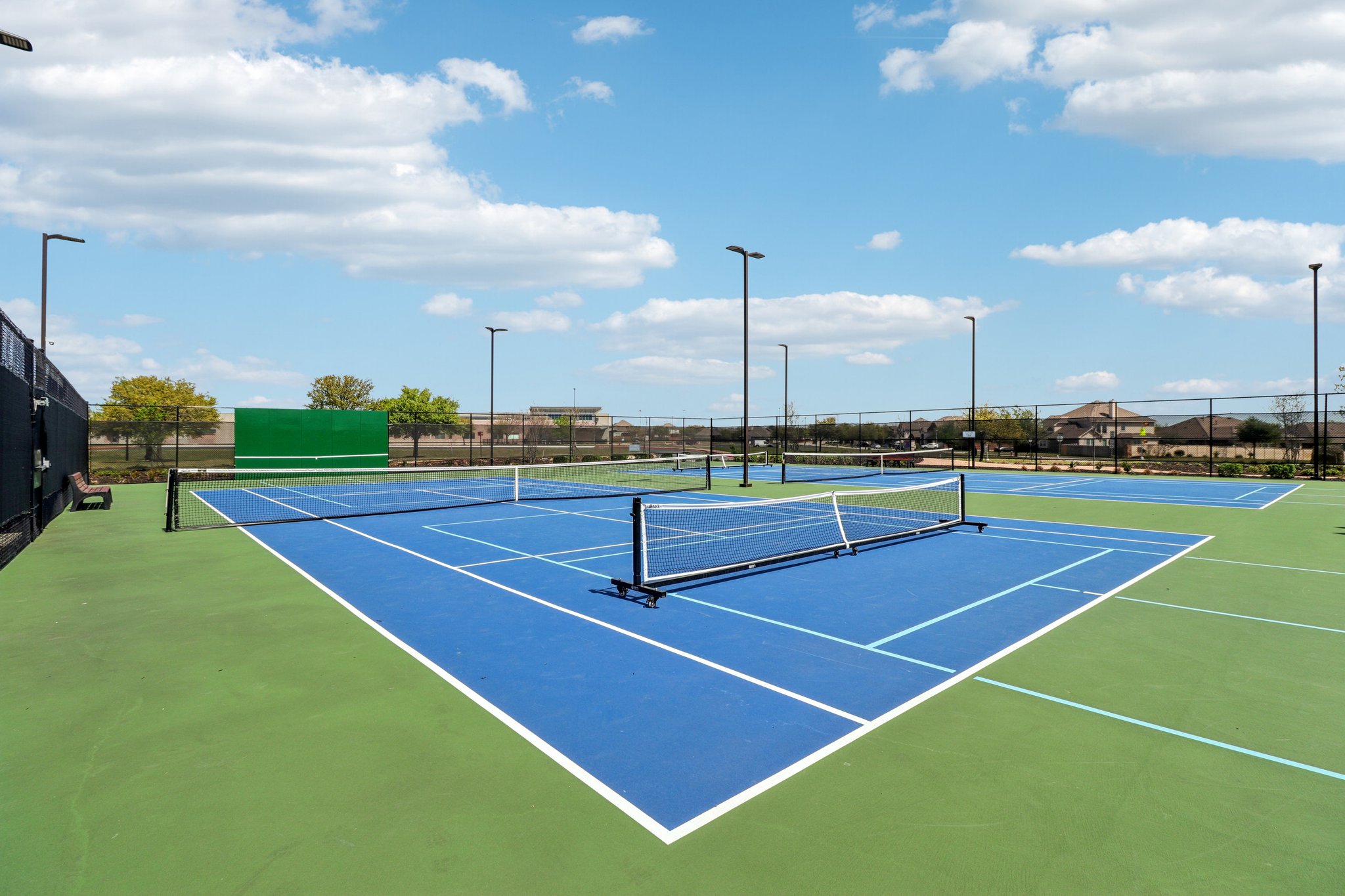 3816 Bow Perch Street Pflugerville, TX 78660 - Photo 21 of 23 a tennis court that has a lot of plants