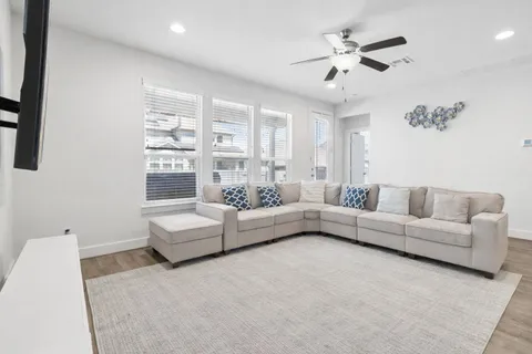 a living room with furniture and a chandelier