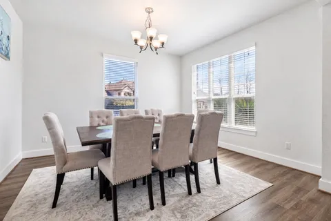a view of a dining room with furniture wooden floor and a chandelier