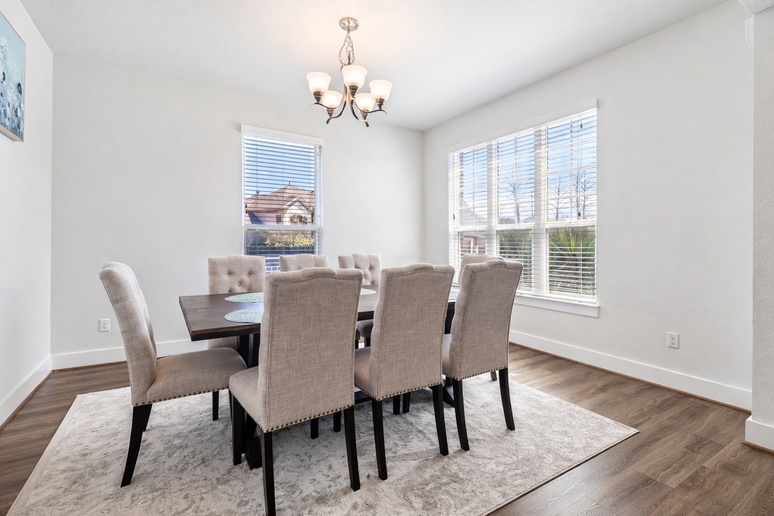 3816 Bow Perch Street Pflugerville, TX 78660 - Photo 6 of 23 a view of a dining room with furniture wooden floor and a chandelier