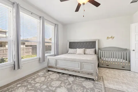 a bedroom with a bed and a large window