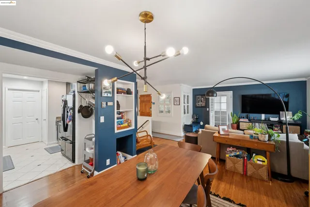 a living room with furniture a flat screen tv and a table