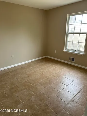 an empty room with a empty space and a window