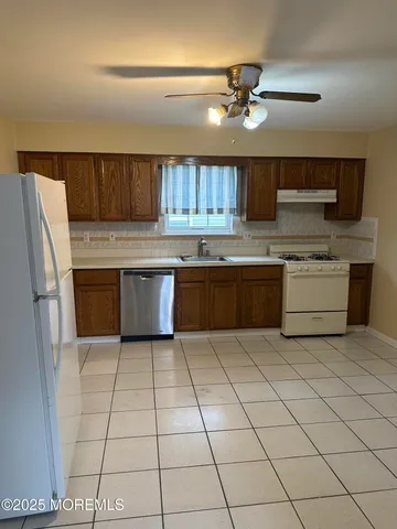 a kitchen with cabinets and stainless steel appliances