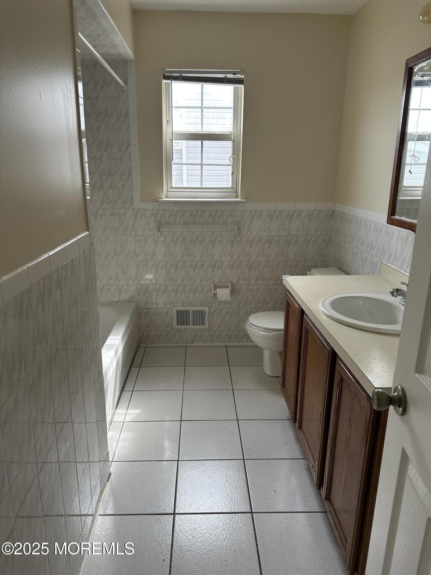 13 Fountain Avenue, Unit A Matawan, NJ 07747 - Photo 9 of 13 a bathroom with a sink a toilet and a mirror