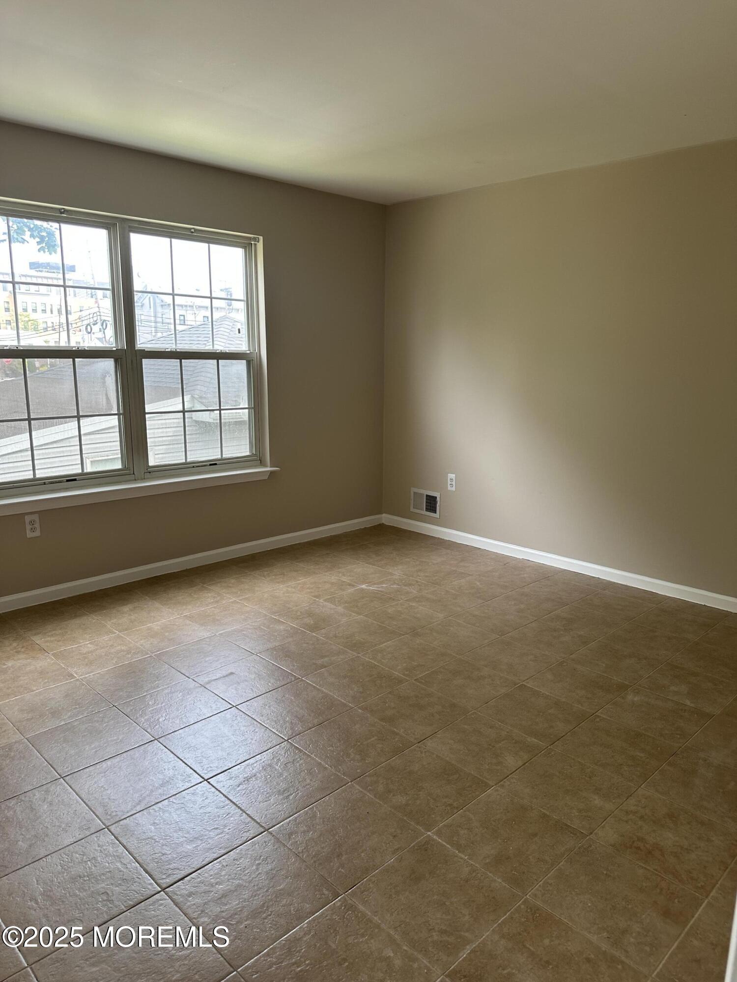 13 Fountain Avenue, Unit A Matawan, NJ 07747 - Photo 10 of 13 an empty room with windows