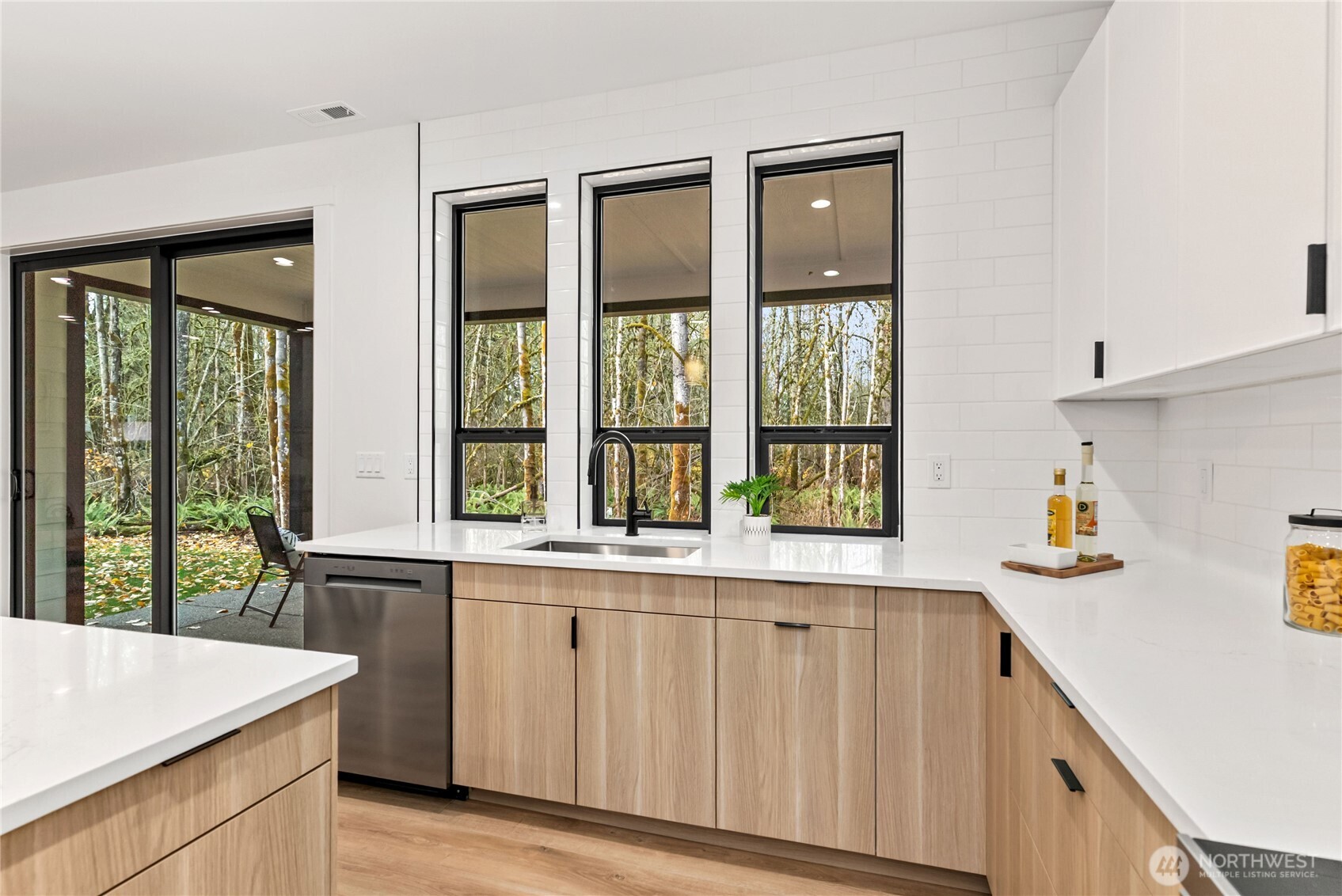15809 239th Street East Graham, WA 98338 - Photo 16 of 40 a kitchen with a window a sink and a refrigerator